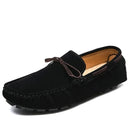 Men’s casual slip-on loafers in black suede with a stylish brown leather tie.