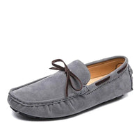 Men’s casual slip-on loafers in grey suede with a stylish bow, blending comfort and elegance.