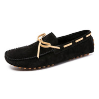 Men’s penny loafers in black suede with tan lace, comfortable design, and rubber pebble outsole.
