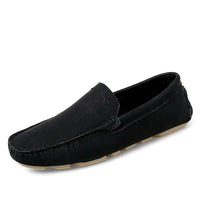 Black slip-on men’s loafers with sleek design and contrast stitching, on a white background.