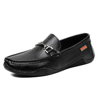 Black leather casual men’s loafers with metal buckle, black sole, and orange label detail