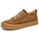 Tan men’s casual leather shoes with white soles and lace-up front.