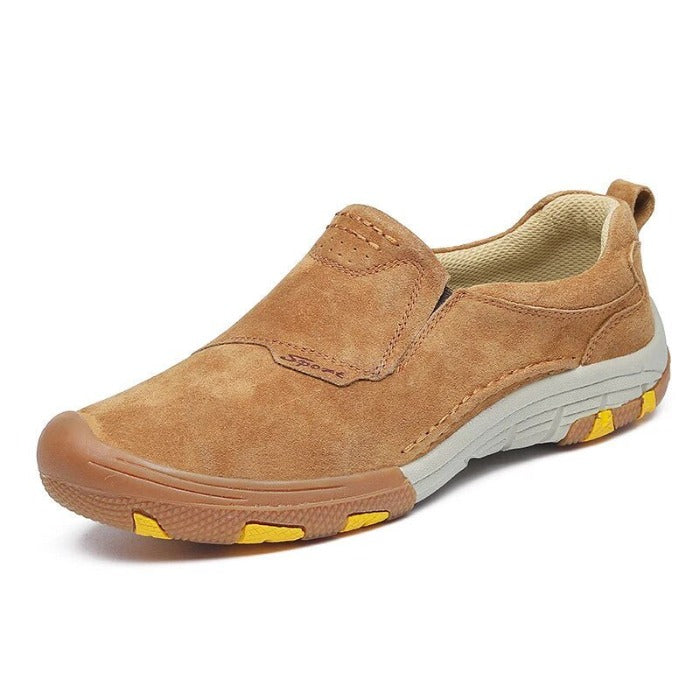 Stylish Men’s slip-on sneakers in tan suede, with white soles and yellow accents on a white background.