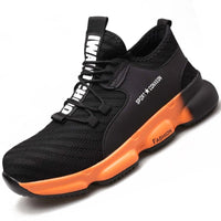 Sneakers work shoes: Stylish black sneaker with orange sole, labeled ‘FASHION’ and ‘SPORT + COMFORT’, featuring a pull tab